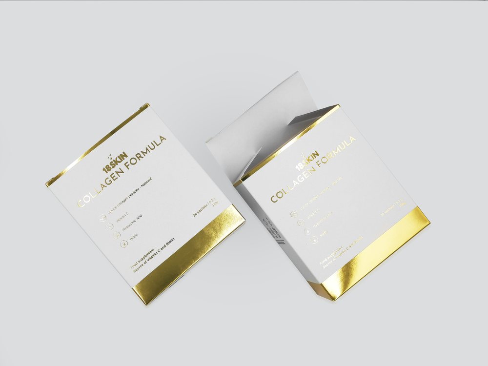 Two white tuck-end boxes for a collagen food supplement with gold foil stamping