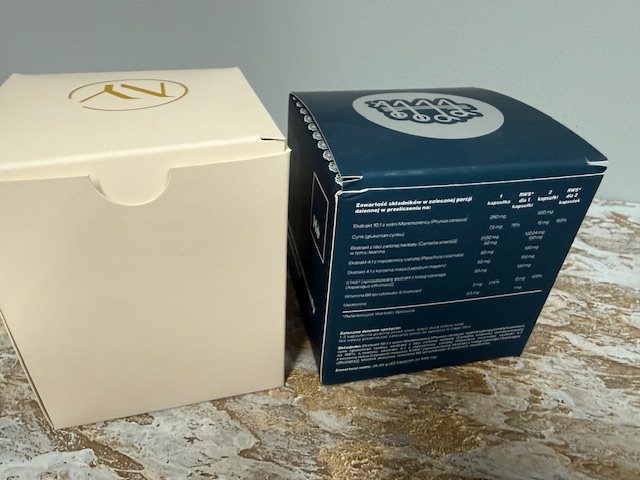 Two supplement boxes, one with a gold logo and one with a printed table of ingredients